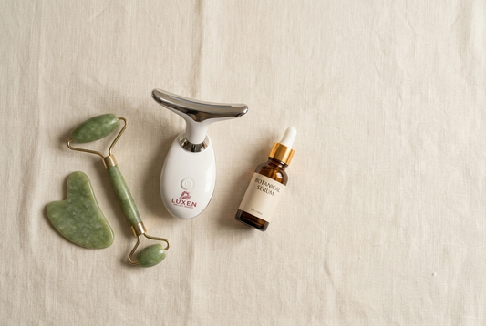 Flat-lay of at-home facial sculpting tools including the Luxen Sculpt & Glow Wand