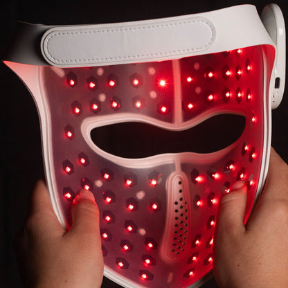 Back of the Luxen Veil — interior laser diode array glowing red through the silicone shell