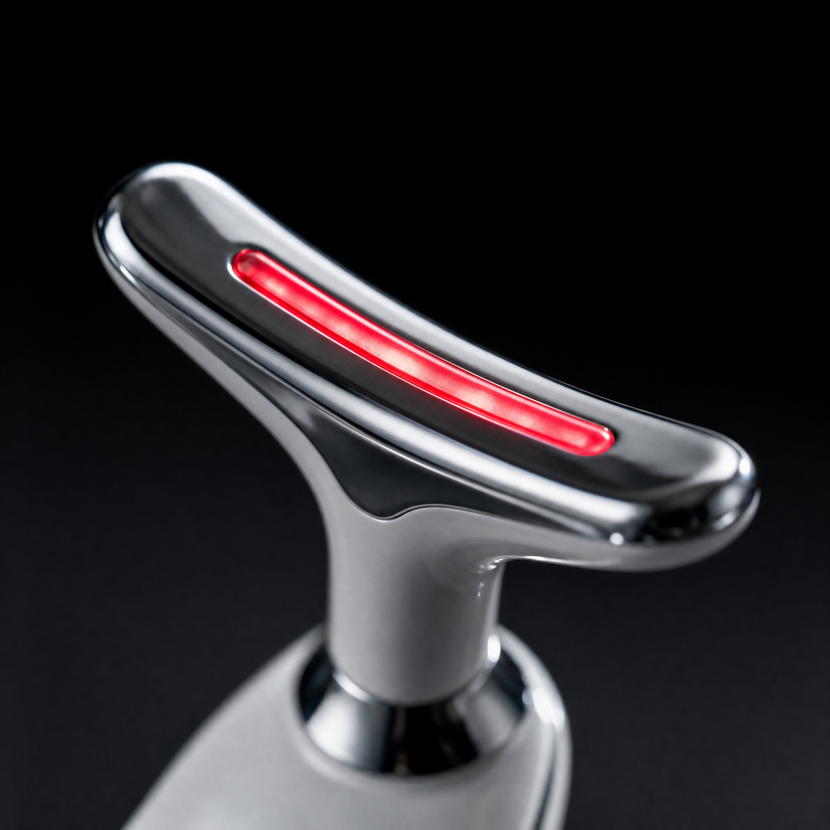 Macro detail of the Luxen Sculpt & Glow Wand chrome treatment head and red LED strip