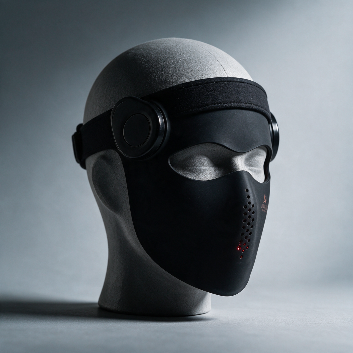 Luxen Veil light therapy mask in black on a display form